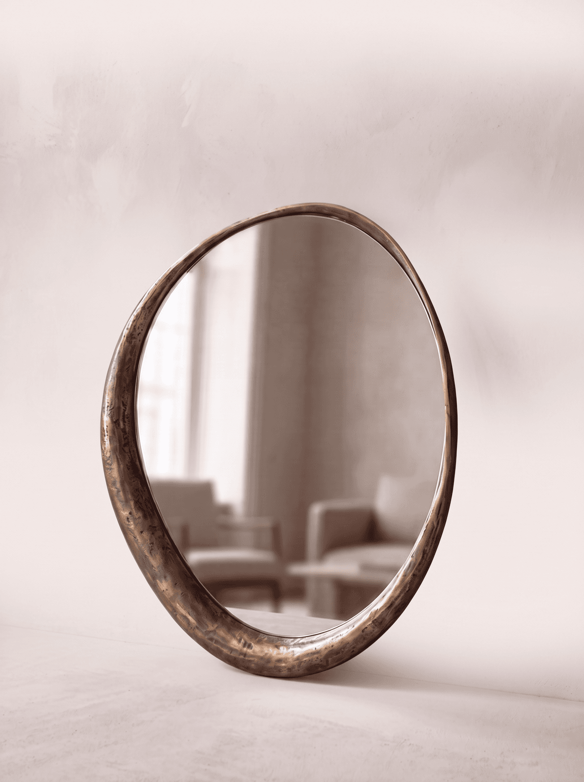 Pebble Off-Round — antique brass cast-metal mirror